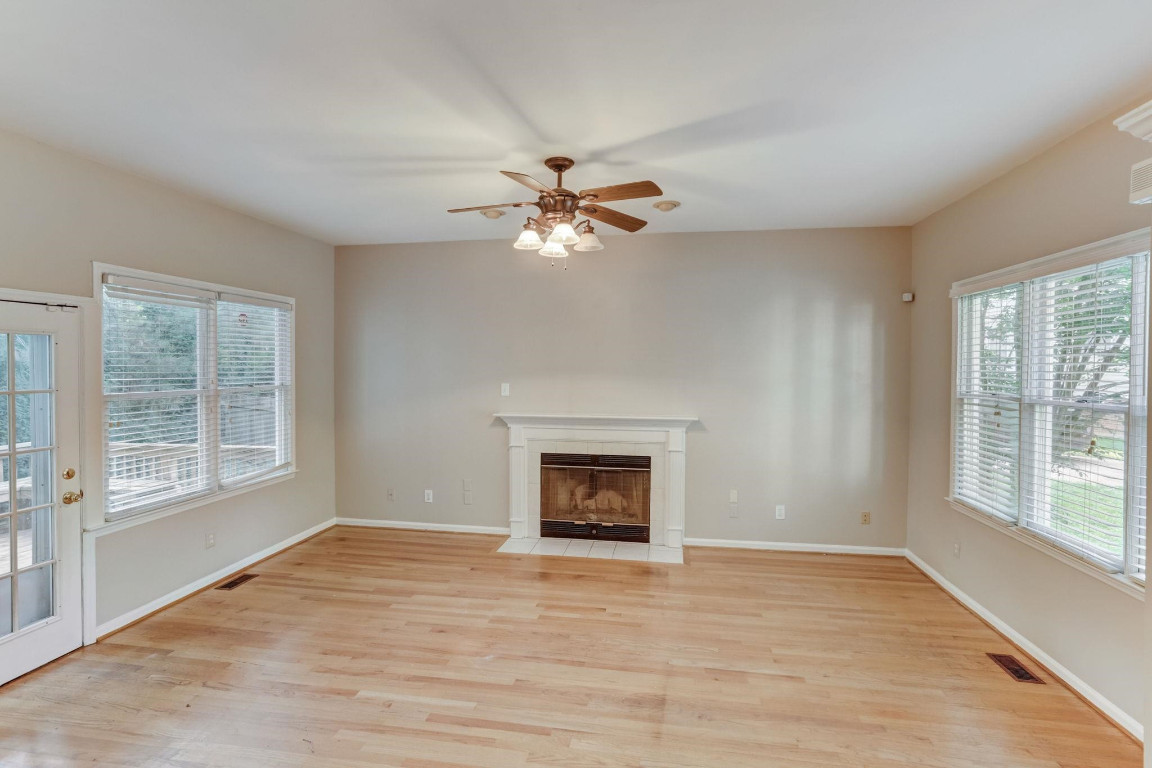 1601 Lethbridge Court Raleigh, NC 27606 - Photo 3 of 17 a view of an empty room with a window and a fireplace