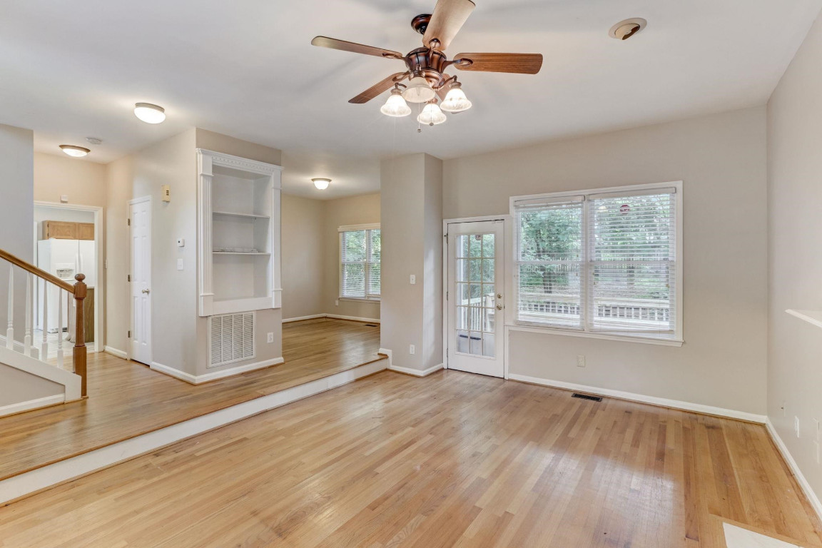 1601 Lethbridge Court Raleigh, NC 27606 - Photo 5 of 17 a view of an empty room with window and wooden floor
