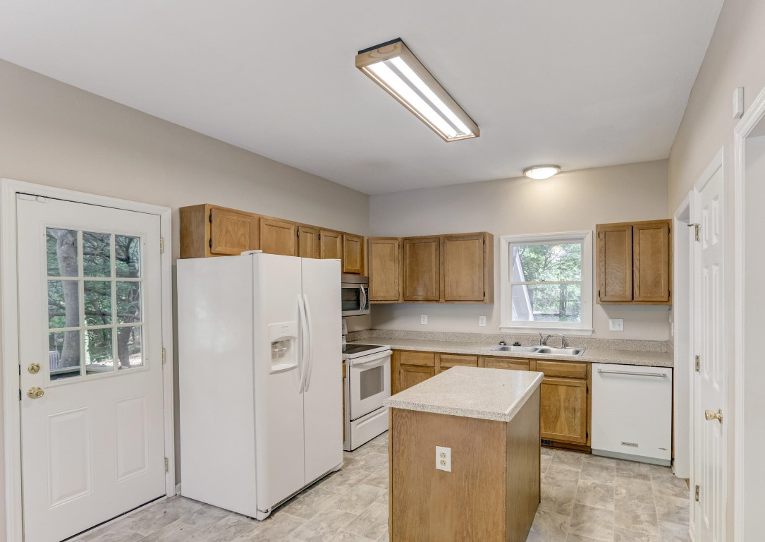 1601 Lethbridge Court Raleigh, NC 27606 - Photo 7 of 17 a kitchen with a stove a refrigerator and a sink