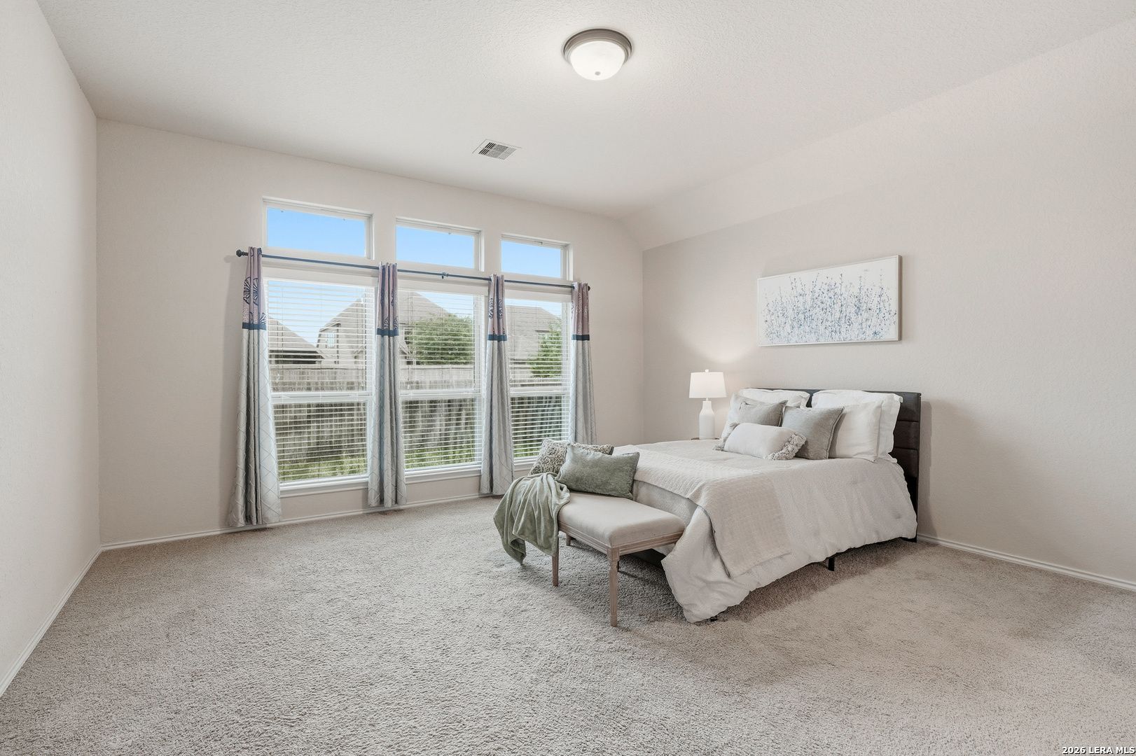 2129 Range Road Seguin, TX 78155 - Photo 22 of 41 a spacious bedroom with a bed and a large window