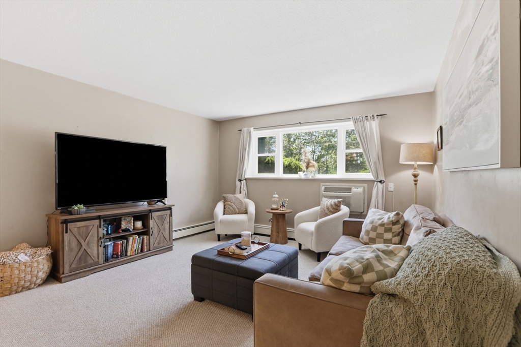 1 Colonial Drive, Unit B1 Andover, MA 01810 - Photo 4 of 14 a living room with furniture and a flat screen tv