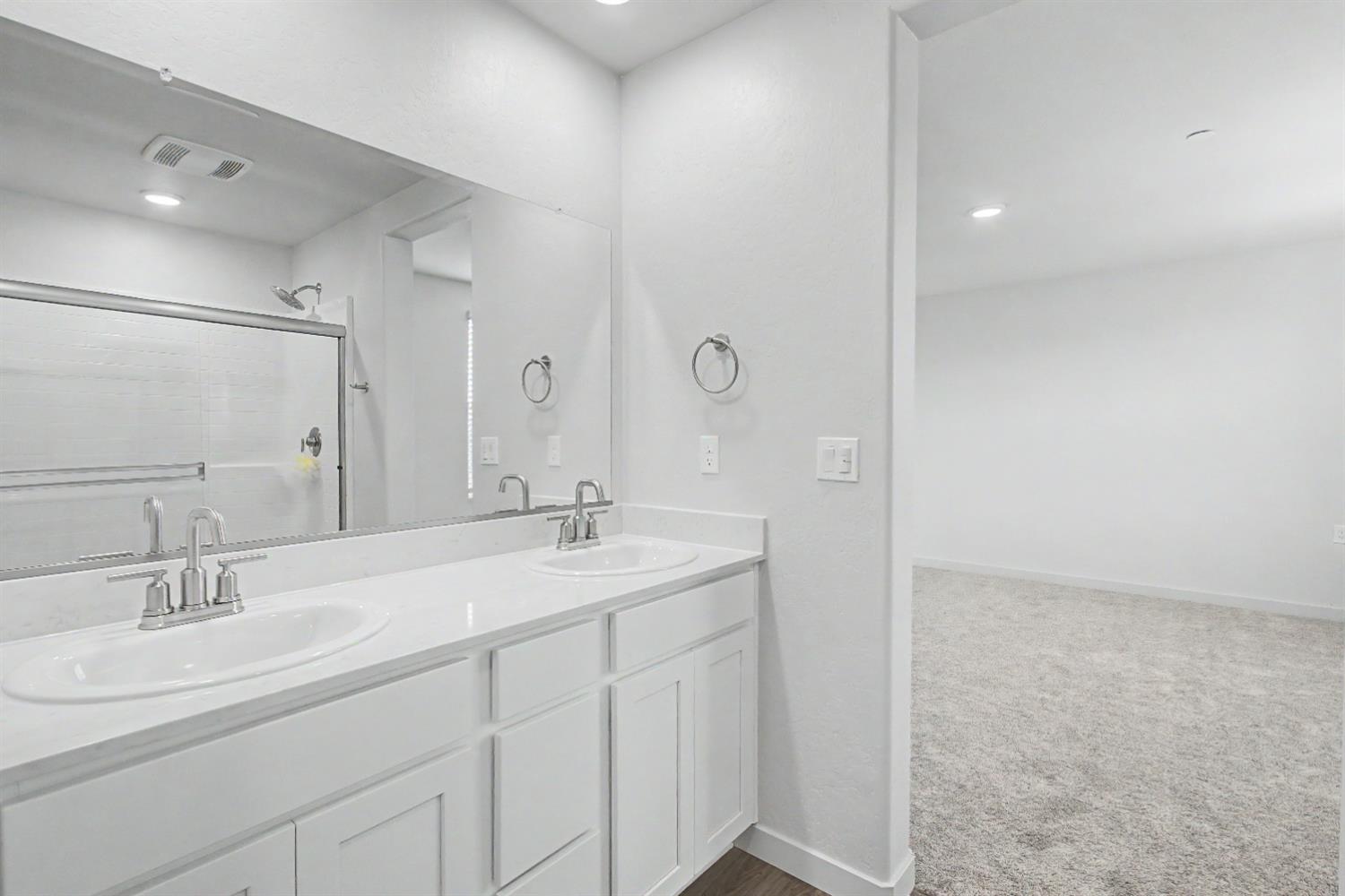 4119 Anise Court Merced, CA 95348 - Photo 12 of 27 a bathroom with a sink double vanity and a mirror