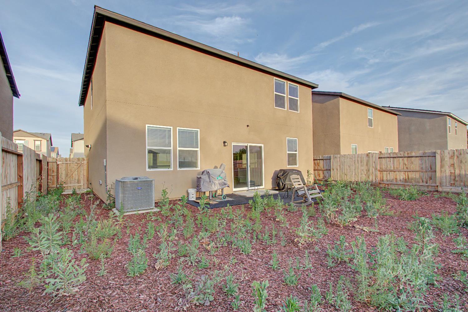 4119 Anise Court Merced, CA 95348 - Photo 24 of 27 a backyard of a house with table and chairs