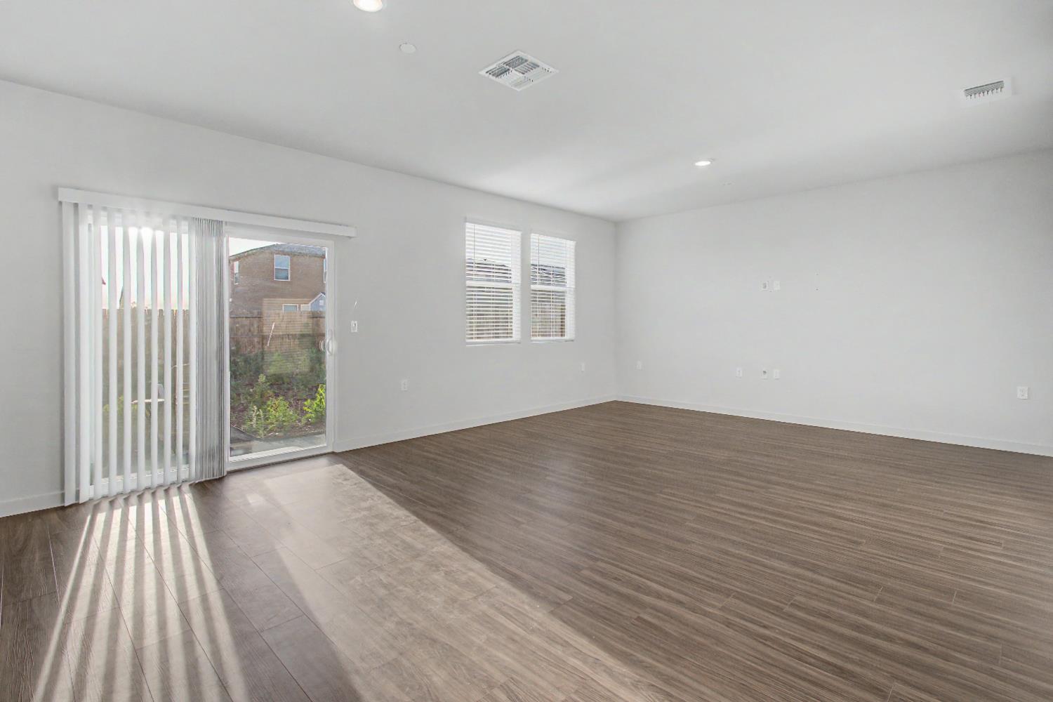 4119 Anise Court Merced, CA 95348 - Photo 3 of 27 wooden floor in an empty room with a window