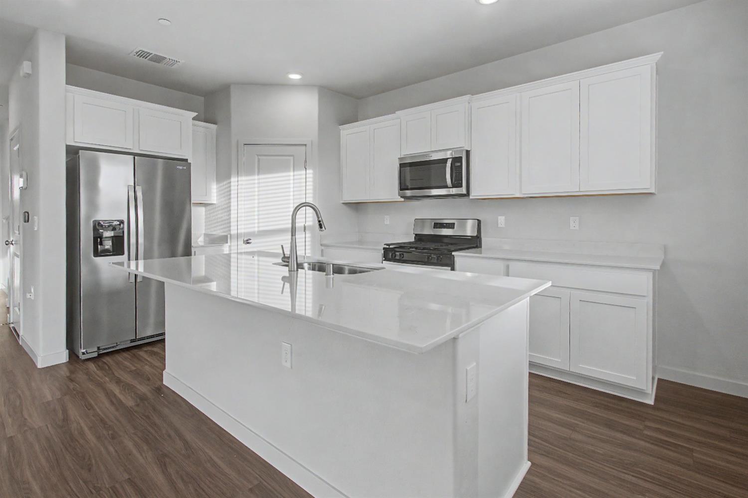 4119 Anise Court Merced, CA 95348 - Photo 4 of 27 a kitchen with stainless steel appliances a refrigerator sink and microwave