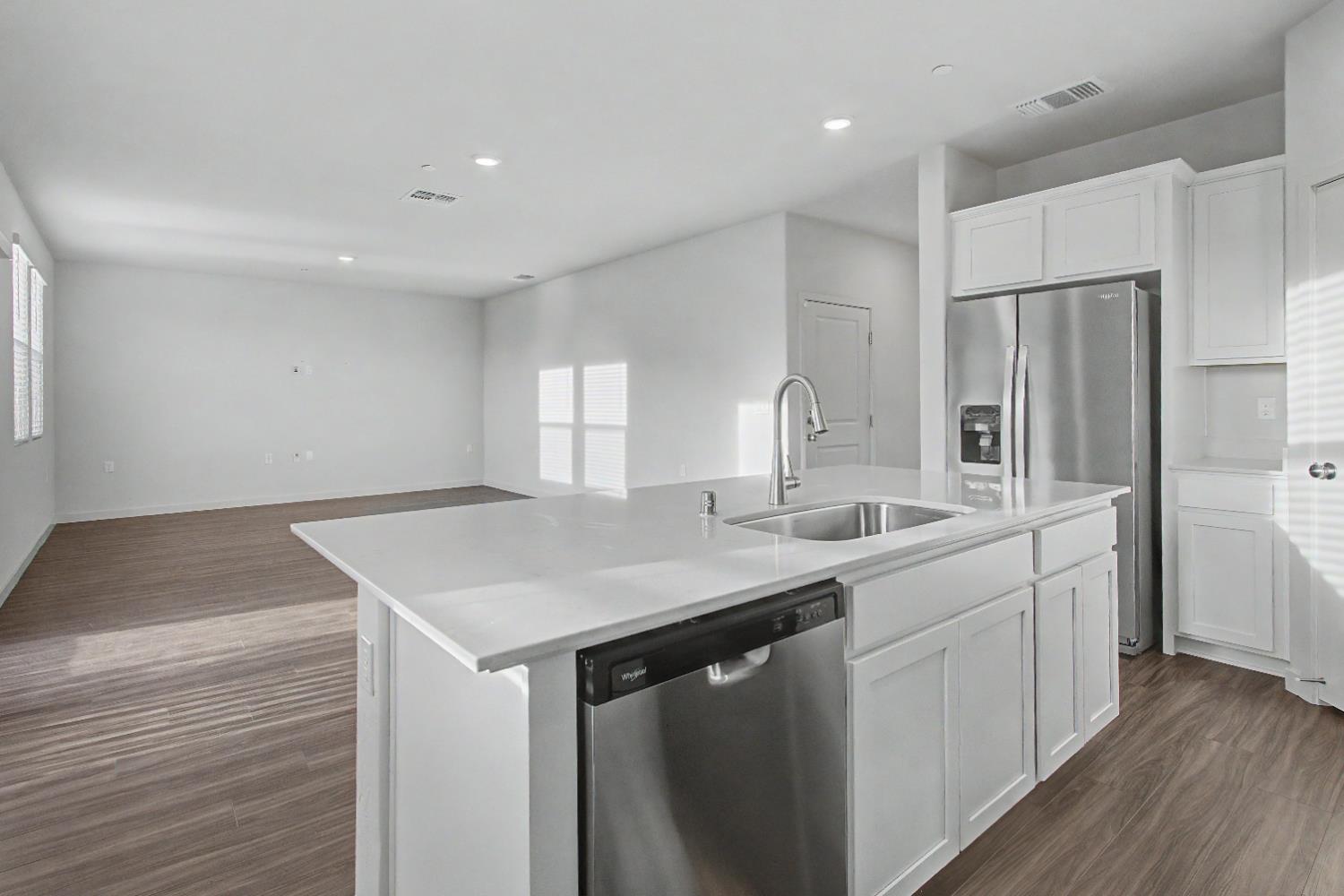 4119 Anise Court Merced, CA 95348 - Photo 5 of 27 a kitchen with a sink a counter space and stainless steel appliances