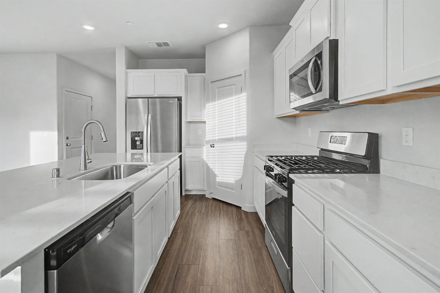 4119 Anise Court Merced, CA 95348 - Photo 6 of 27 a kitchen with stainless steel appliances granite countertop a sink stove and refrigerator