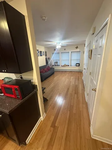 a living room with a couch wooden floor and a flat screen tv