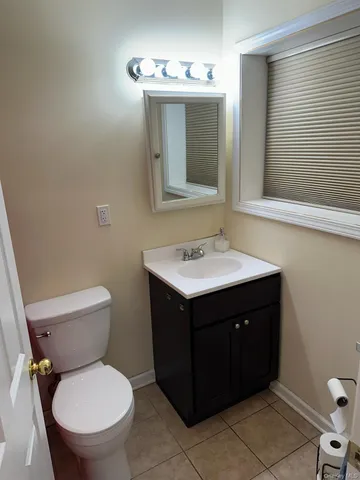 a bathroom with a sink vanity mirror and toilet