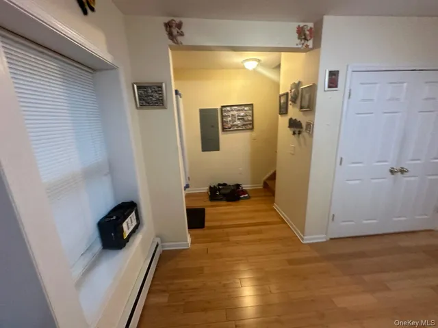 a living room with furniture and a air conditioner vent