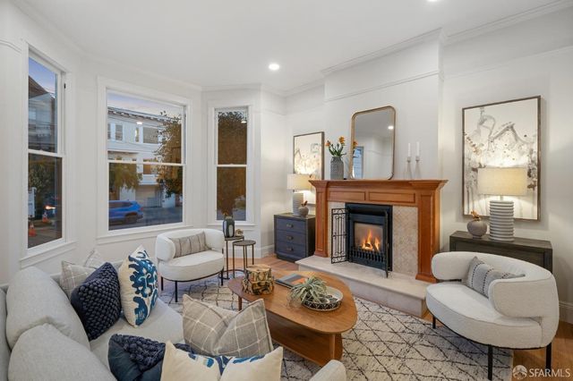 a living room with furniture and a chandelier