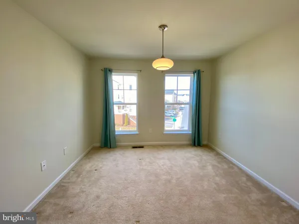 a view of room with wooden floor and floor to ceiling window