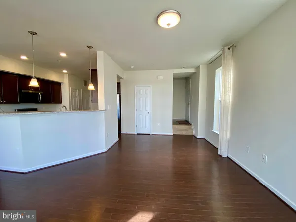 a view of a kitchen with a refrigerator and a stove