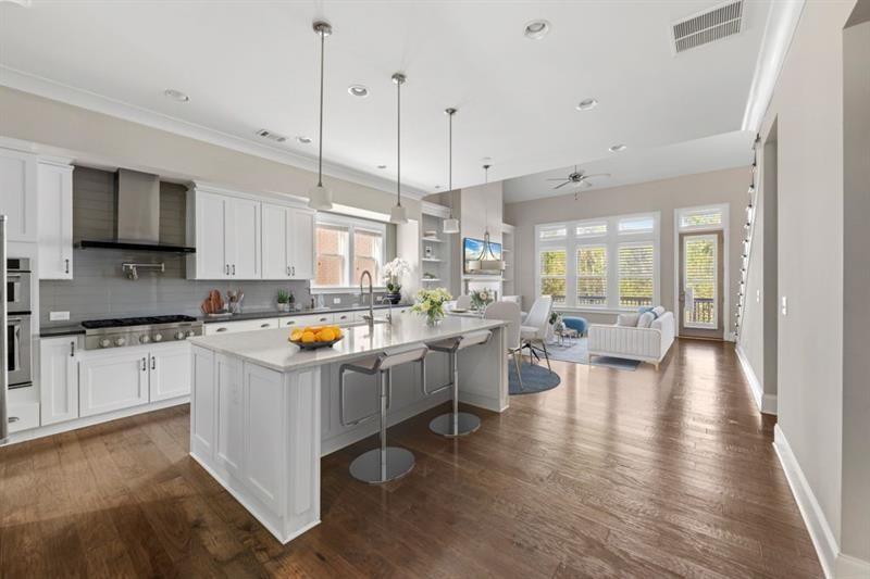 6454 Meridian Way Atlanta, GA 30328 - Photo 11 of 63 a kitchen that has a lot of cabinets a sink and appliances in it