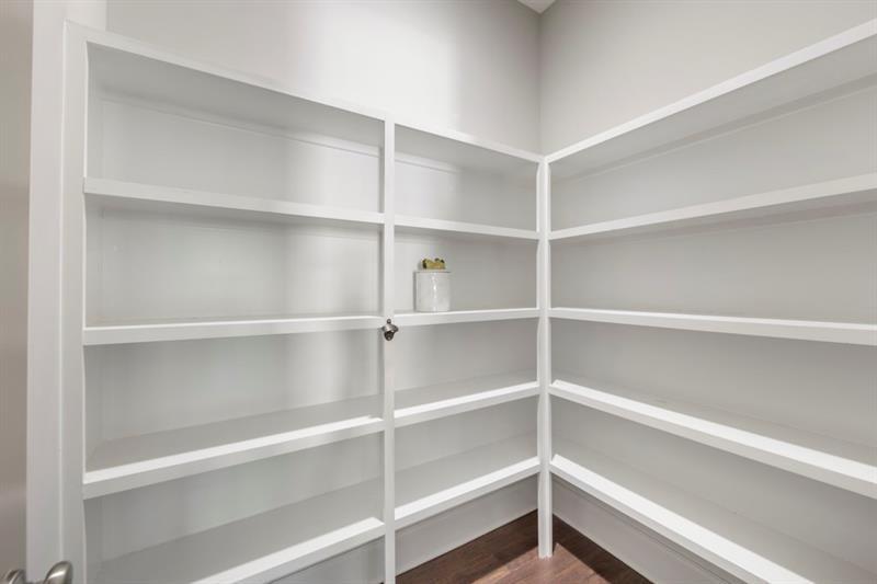 6454 Meridian Way Atlanta, GA 30328 - Photo 15 of 63 a view of walk in closet with empty racks