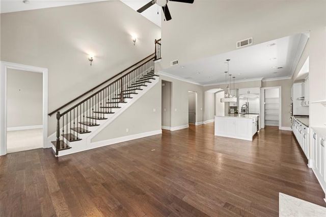 an empty room with closet and fan