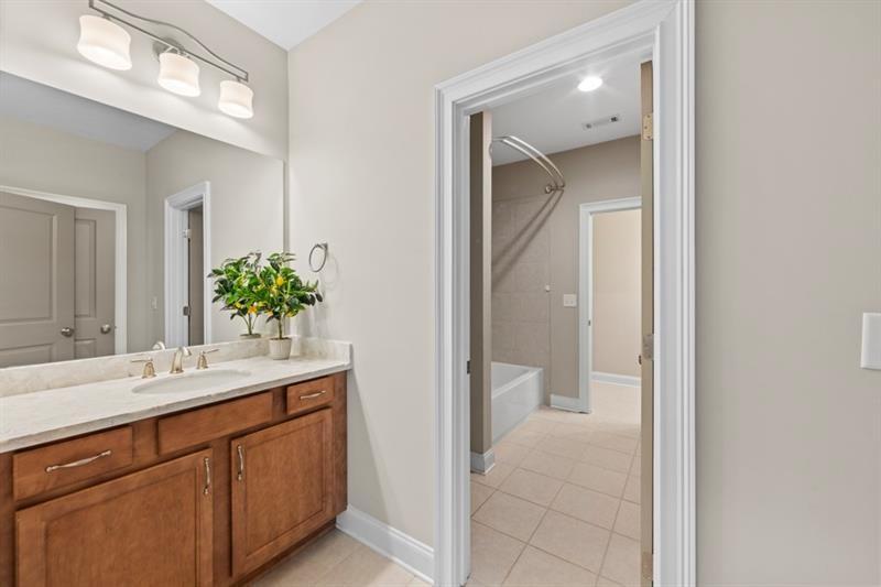 6454 Meridian Way Atlanta, GA 30328 - Photo 35 of 63 a bathroom with a sink and a mirror