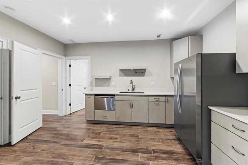 6454 Meridian Way Atlanta, GA 30328 - Photo 45 of 63 a kitchen with stainless steel appliances a refrigerator and a stove