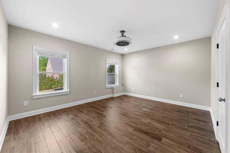 6454 Meridian Way Atlanta, GA 30328 - Photo 49 of 63 an empty room with wooden floor and windows