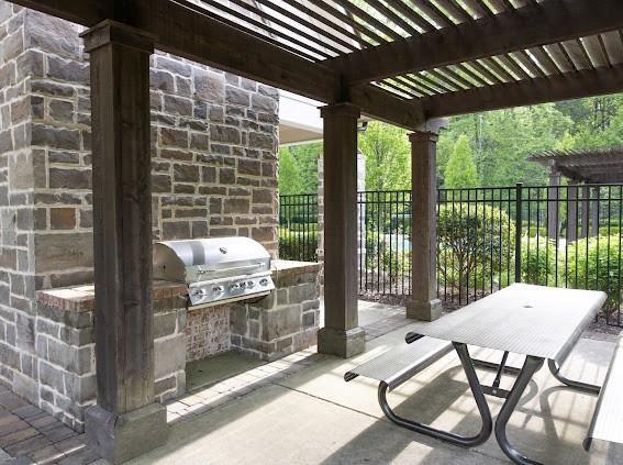 6454 Meridian Way Atlanta, GA 30328 - Photo 61 of 63 a view of a patio with a table chairs and a backyard