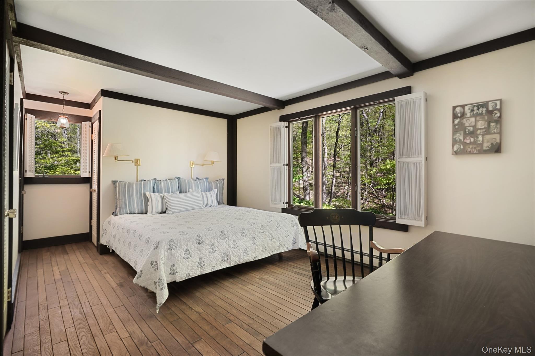 334 Pine Brook Road Pound Ridge, NY 10506 - Photo 13 of 28 a bedroom with a bed and wooden floor