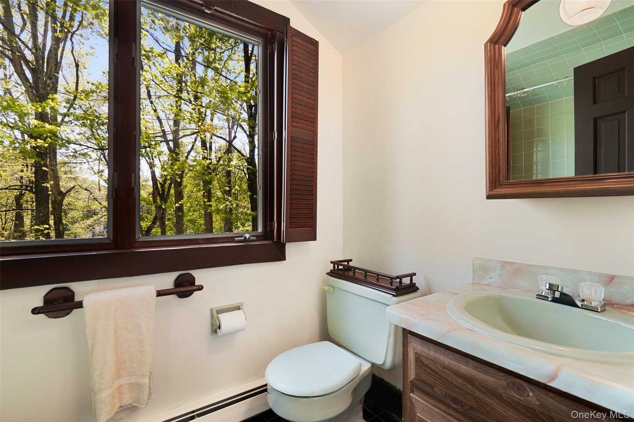 334 Pine Brook Road Pound Ridge, NY 10506 - Photo 20 of 28 a bathroom with a sink a toilet and a window