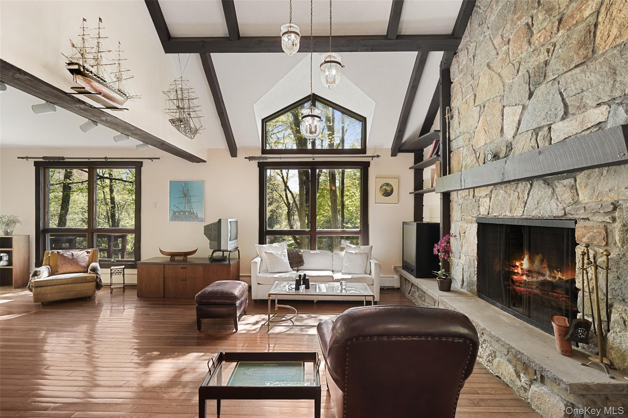 334 Pine Brook Road Pound Ridge, NY 10506 - Photo 4 of 28 a living room with furniture a fireplace and a floor to ceiling window