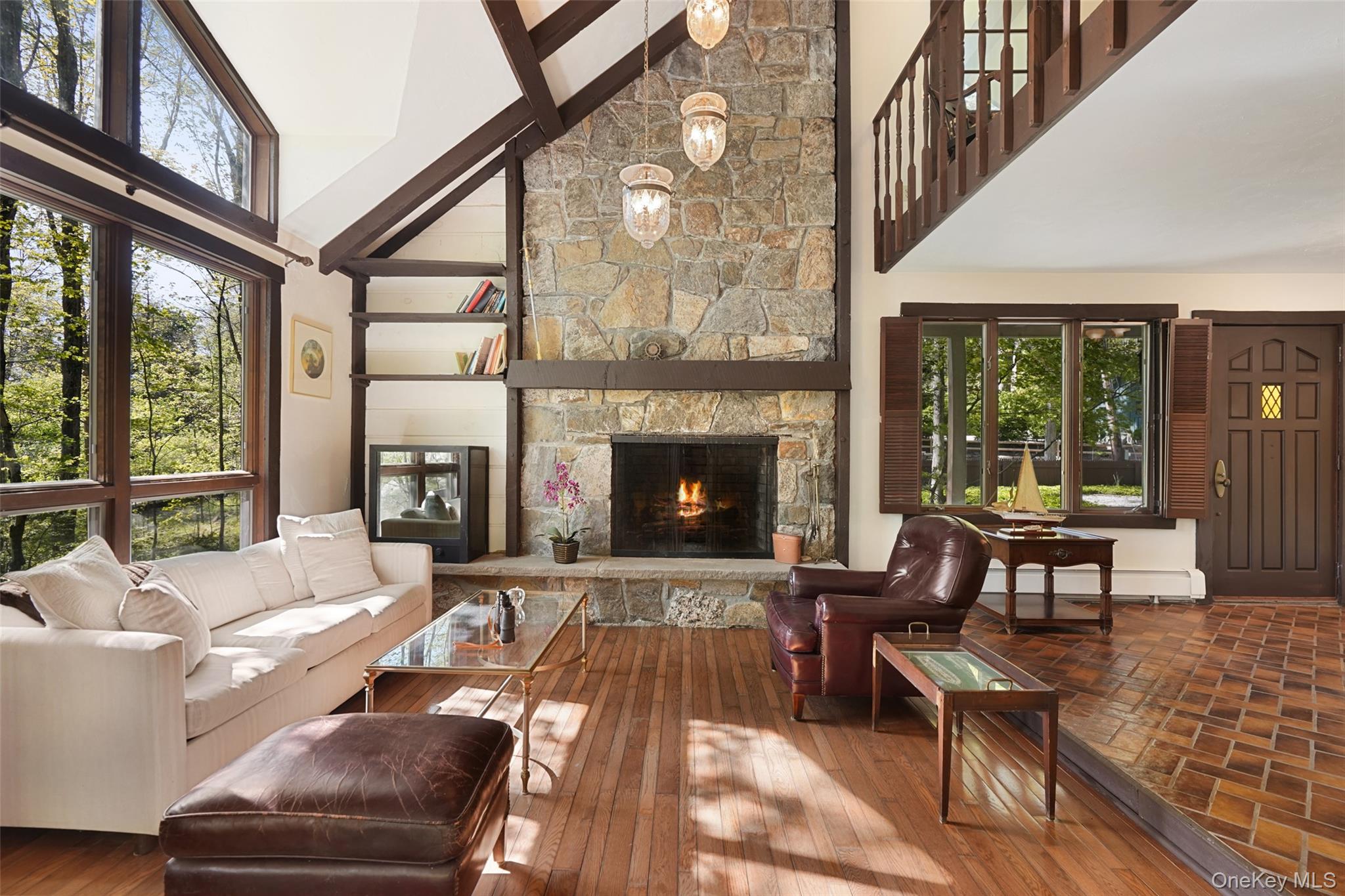 334 Pine Brook Road Pound Ridge, NY 10506 - Photo 5 of 28 a living room with furniture a fireplace and a floor to ceiling window