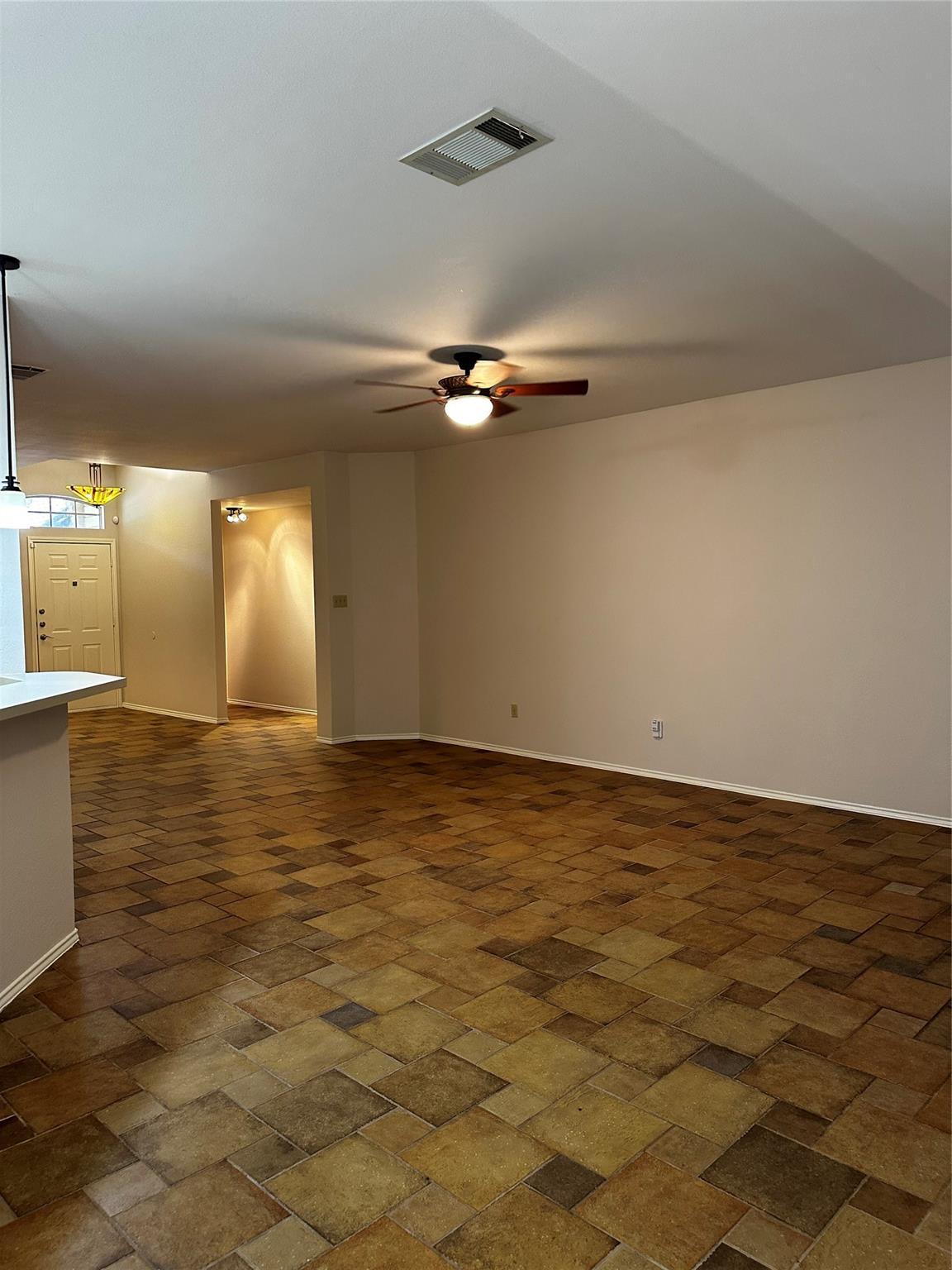 8007 Bounty Trail Austin, TX 78749 - Photo 13 of 32 A spacious living area featuring patterned tile flooring and a ceiling fan with integrated lighting.