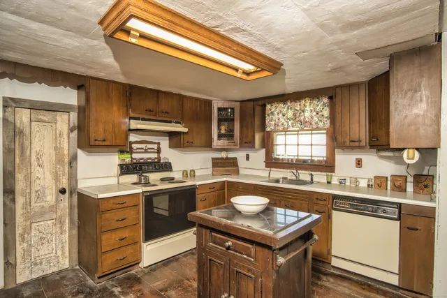 a kitchen with a sink stove and cabinets