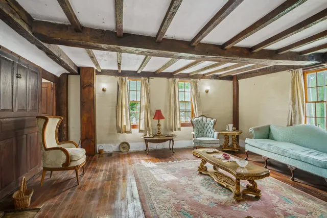 a living room with furniture a wooden floor and a table