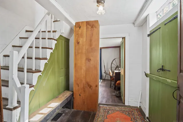 a bedroom with a bed and a refrigerator