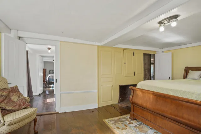 a bedroom with bed and a dresser