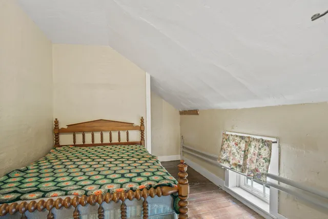 a hallway with wooden floor a fireplace
