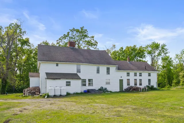 a view of a house with a swimming pool and a yard