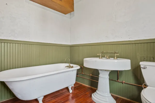 a bathroom with a sink a toilet and bathtub