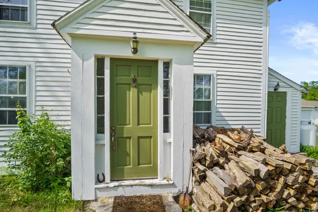 a front view of a house with a green gate