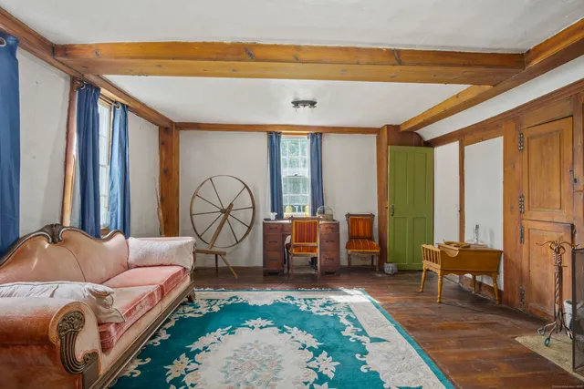 a living room with furniture a large window and a rug