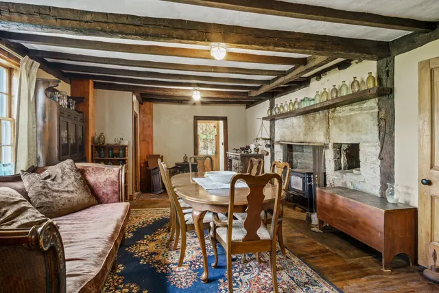 a dining room with furniture and a window
