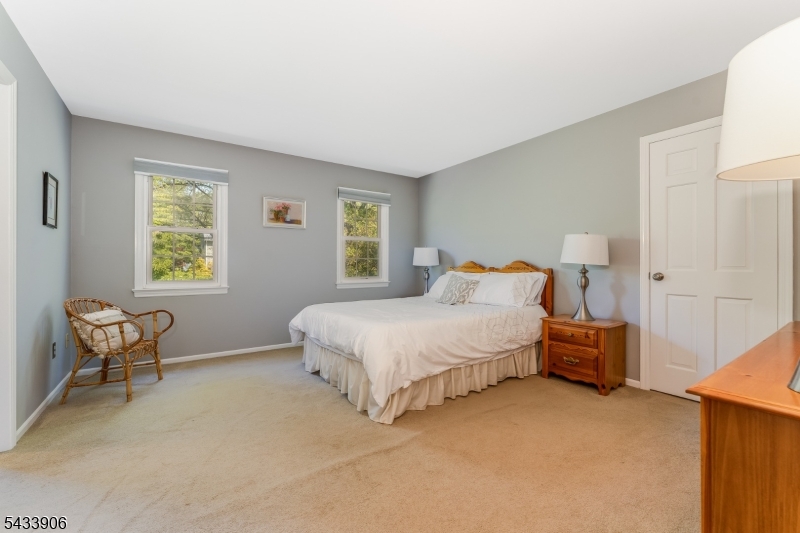 14 Lexington Road Annandale, NJ 08801 - Photo 22 of 47 a spacious bedroom with a bed and chair