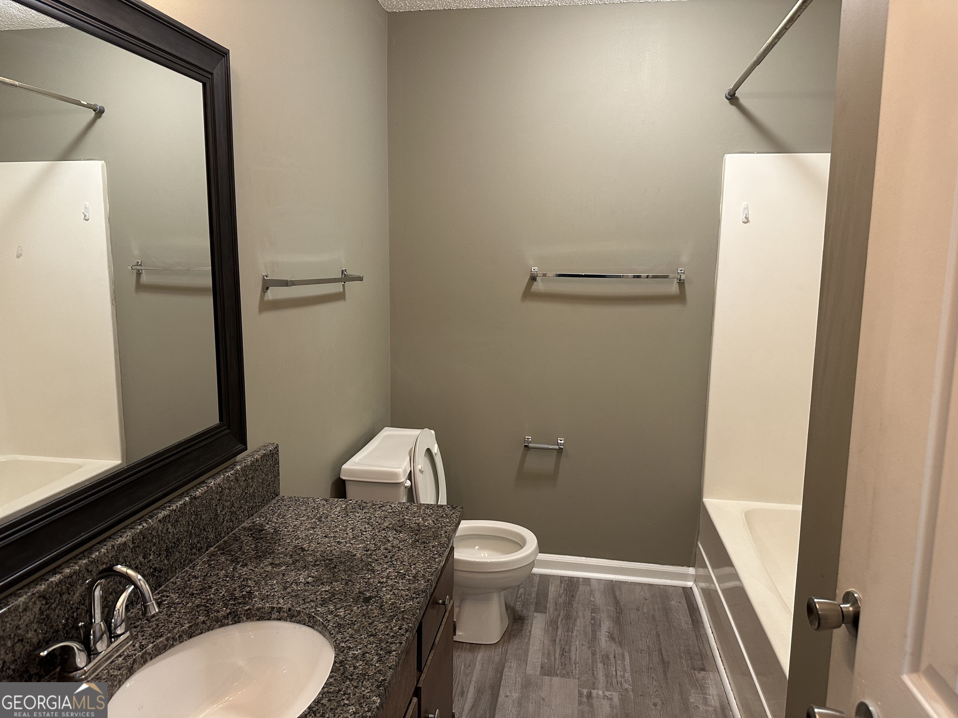 205 Maret Street Hartwell, GA 30643 - Photo 11 of 38 a bathroom with a granite countertop toilet and a sink