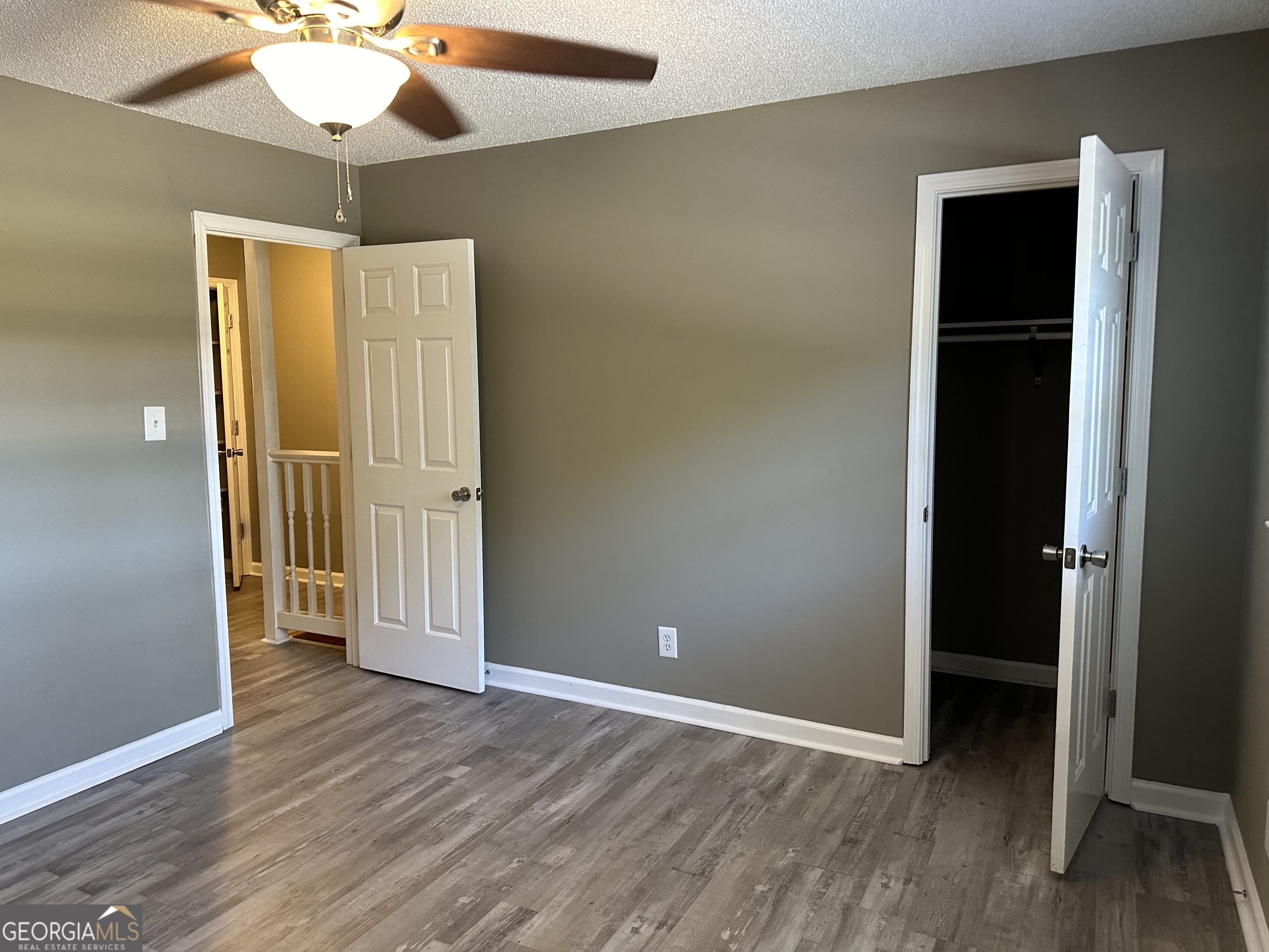 205 Maret Street Hartwell, GA 30643 - Photo 13 of 38 an empty room with wooden floor a ceiling fan