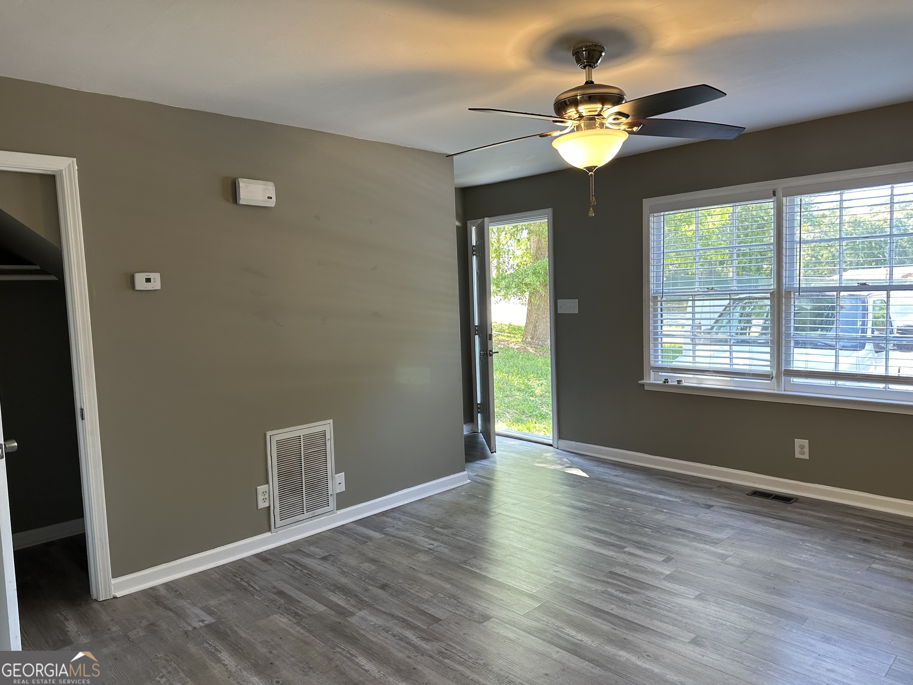 205 Maret Street Hartwell, GA 30643 - Photo 17 of 38 a view of an empty room with window and wooden floor