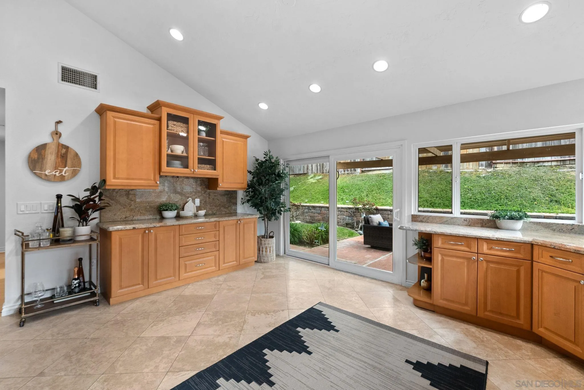 111 Little Oaks Road Encinitas, CA 92024 - Photo 11 of 25 a large kitchen with a large window and stainless steel appliances
