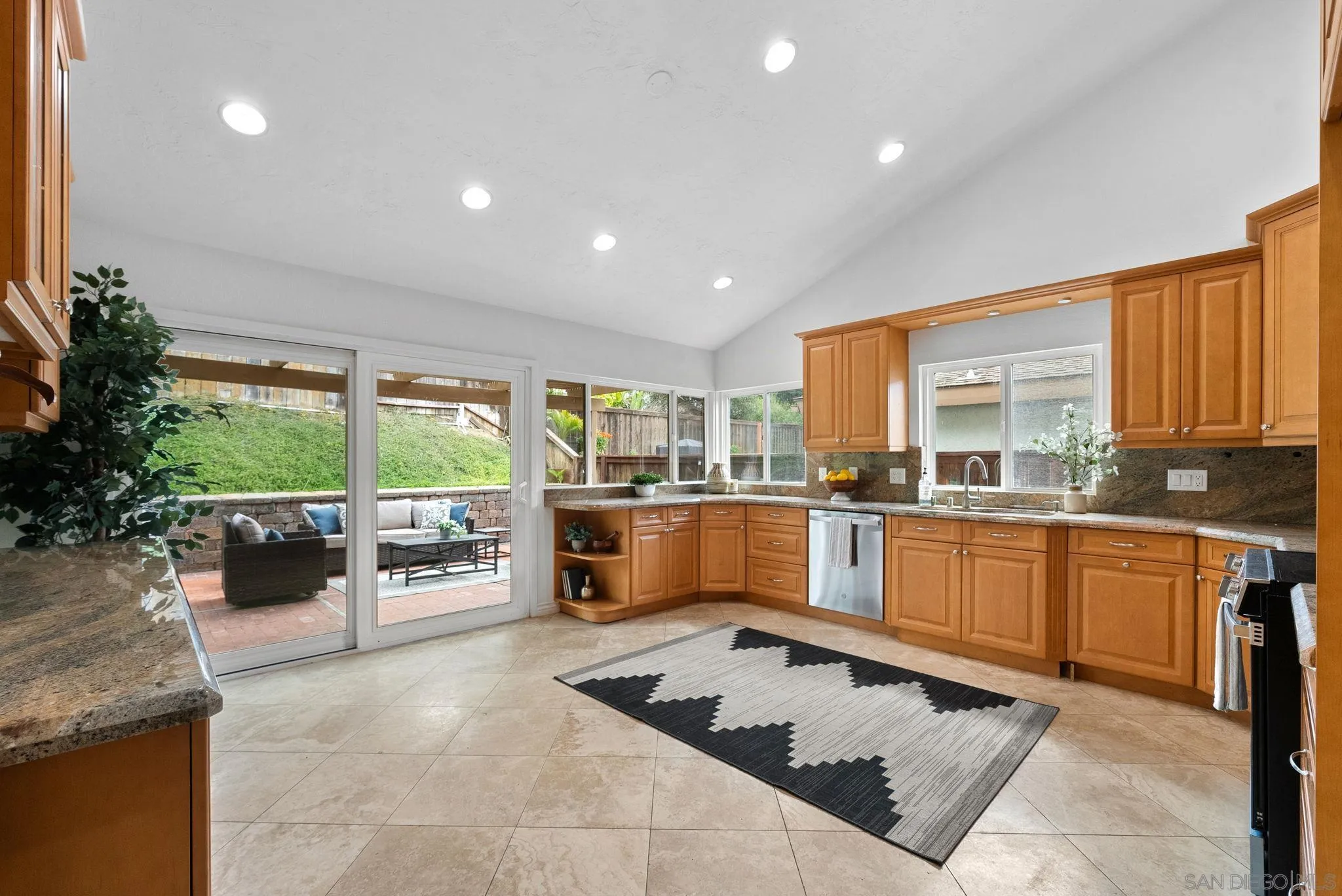 111 Little Oaks Road Encinitas, CA 92024 - Photo 3 of 25 a kitchen with sink refrigerator and stove