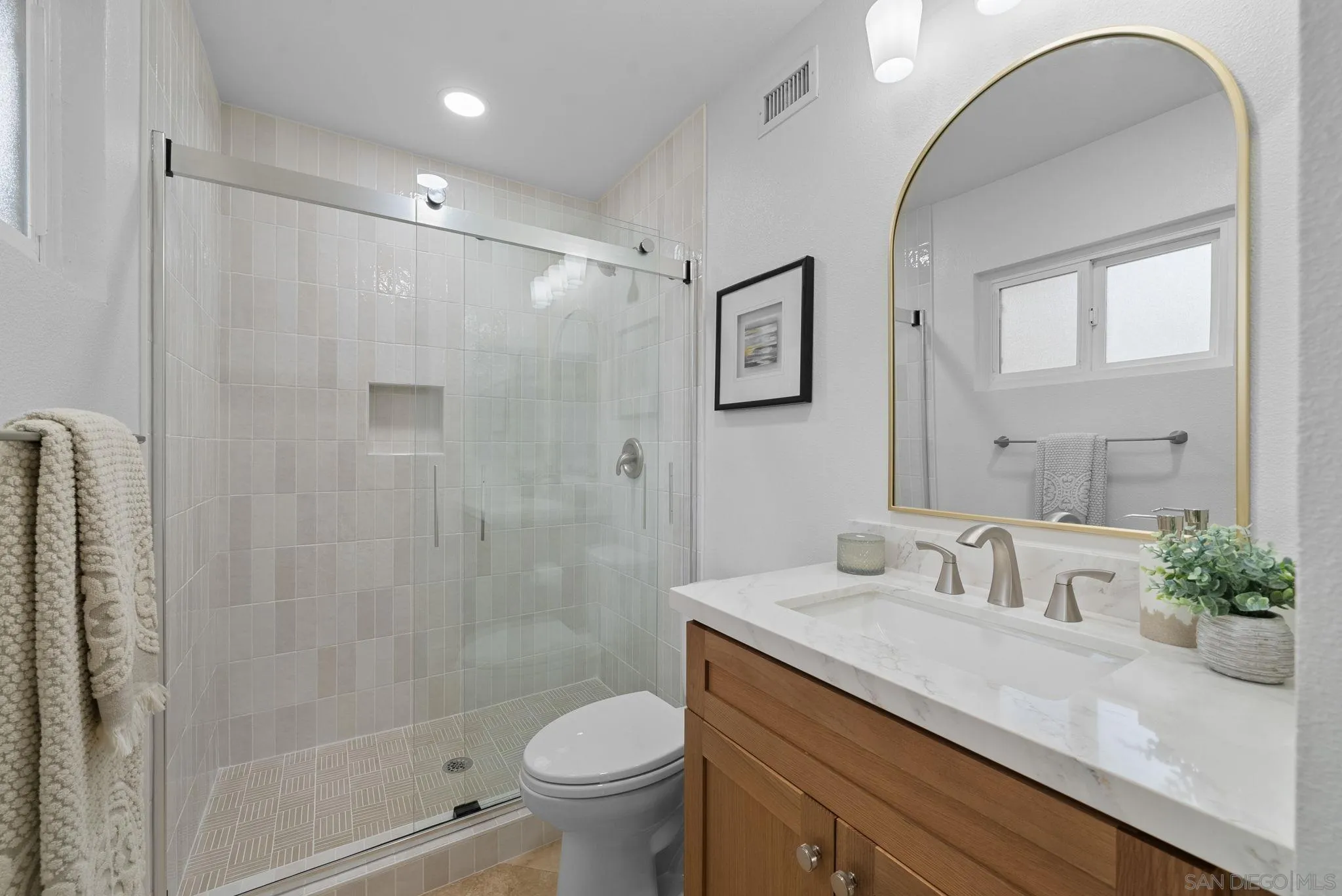 111 Little Oaks Road Encinitas, CA 92024 - Photo 6 of 25 a bathroom with a granite countertop sink a toilet and shower