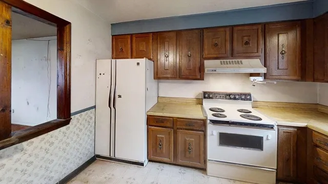 a kitchen with a stove and a refrigerator