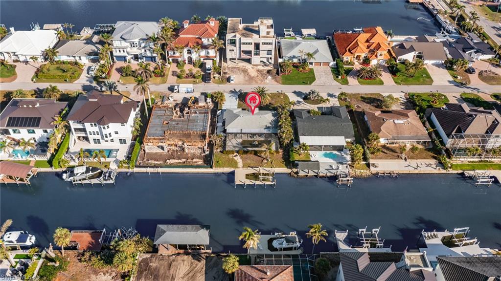418 Seabee Avenue Naples, FL 34108 - Photo 13 of 19 Aerial view of property and surrounding area with a large body of water and nearby suburban area