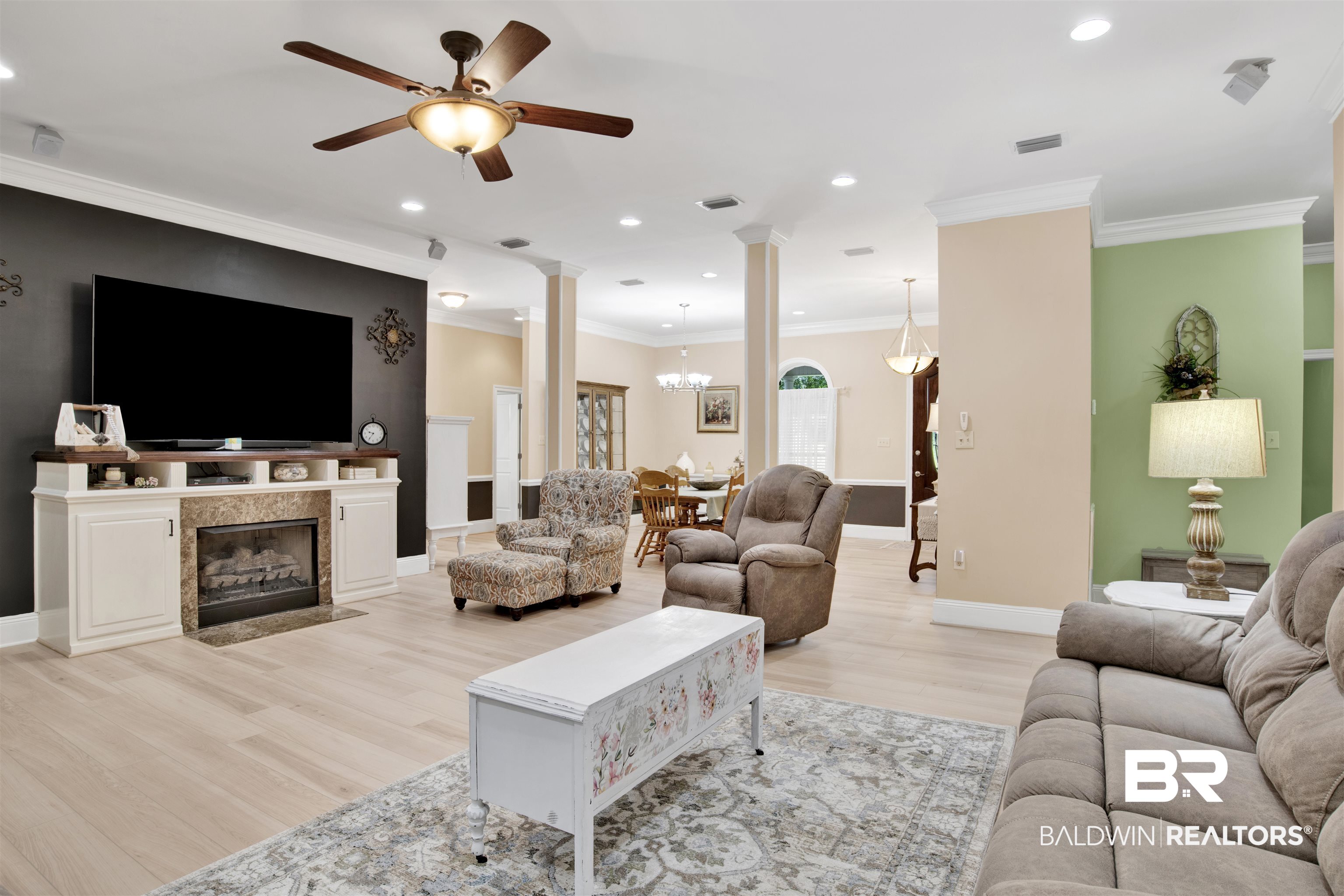 4340 Hamilton Oaks Lane Mobile, AL 36695 - Photo 13 of 51 Living room with crown molding, ornate columns, ceiling fan with notable chandelier, and light hardwood / wood-style flooring