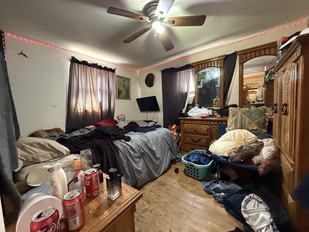 311 Northeast 3rd Seminole, TX 79360 - Photo 11 of 21 a bedroom with furniture and wooden floor